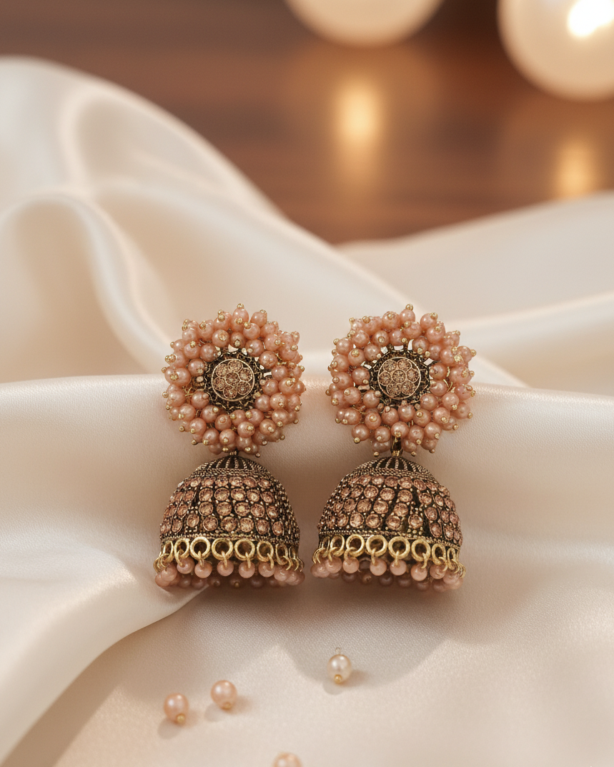 Pair of pearl earrings on a soft fabric background