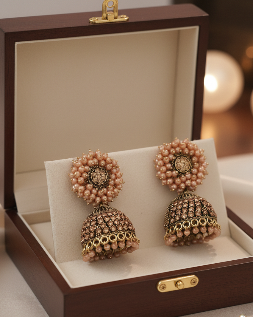 Pair of pearl earrings in a jewelry box with a blurred background